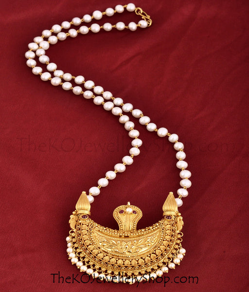 A traditional temple jewellery pendant in a string of pearls